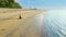 Beautiful woman exercising yoga on the Sanur beach