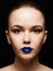 Beautiful woman face with blue lips gloss