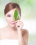 Beautiful woman face portrait with green leaf