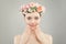 Beautiful woman face. Spa model girl with clear skin, hand with manicured nails and roses flowers on head