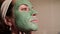 Beautiful woman with facial mask. Spa therapy for young woman receiving facial mask.