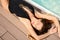 Beautiful woman in fashiom swimsuit relax near spa pool