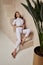 Beautiful woman fashion model brunette hair tanned skin wear white overalls button suit sandals high heels accessory bag clothes