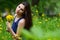 Beautiful woman in the field with dandelions