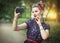 Beautiful woman in fifties style taking picture of herself