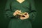 Beautiful woman figure in dark green 50`s dress holding vintage book