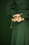 Beautiful woman figure in dark green 50`s dress holding vintage keys