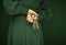 Beautiful woman figure in dark green 50`s dress holding vintage keys