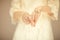 Beautiful woman figure in vintage boho wedding dress showing her hands