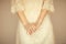 Beautiful woman figure in vintage boho wedding dress showing her hands