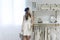 Beautiful woman fits on a white dress in the shopping mall at a atelier