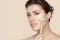 Beautiful woman with fresh clean skin massaging face with jade roller. Conceptual of skin care and beauty facial treatments with