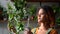 Beautiful woman gardener takes care of plant and poses at home room spbd.