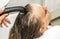 Beautiful woman getting hair wash in a hair salon