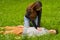 Beautiful woman giving first aid to a handsome young man, cardiopulmonary resuscitation, in a grass background