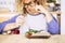 Beautiful woman with glasses looking with disgust some vegetables and rise on the table - she is going to eat healthy to feel