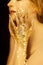 Beautiful woman in gold, golden hands, glitter sensual glamour luxury
