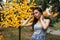 Beautiful woman in a gray T-shirt near the lights in the park