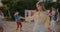 Beautiful woman grooving against friends dancing at beach