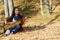 Beautiful woman guitar player girl in the forest