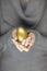 Beautiful woman hands holden golden easter egg with perfect french nails