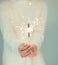 Beautiful woman hands holding sparkler lights, cozy, bright winter sweater,