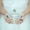 Beautiful woman hands holding vintage antique sugar pot