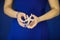 Beautiful woman hands with perfect nail polish holding little starfish in front of blue dress