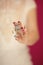 Beautiful woman hands with perfect pink nail polish holding little octopus brooch