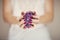 Beautiful woman hands with perfect pink nail polish holding violet amethyst crystal