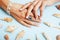 Beautiful woman hands with pink manicure holding plate with pearls and sea shells, luxury jewelry concept