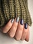 Beautiful woman hands with professional Russian manicure nails in khitted sweater