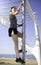 Beautiful woman hanging on bar at outdoor training spot or street workout in Barcelona beach & x28;SPAIN