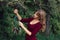 Beautiful woman hanging dream catcher on tree