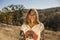 Beautiful woman with happy smile standing outdoors after a great healthy hike