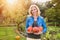 Beautiful woman harvesting pumpkins