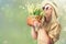 Beautiful woman in hat and with a basket of field daisies in sunny summer day.