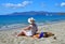 Beautiful woman in a hat enjoys the view of the beach of Naxos island in Greece.