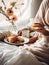 Beautiful woman having breakfast in bed, home bedroom interior with bright morning light, healthy food on cozy decorated