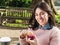 Beautiful Woman Having a Muffin Outside at the Coffee Shop