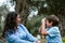 Beautiful woman and her cute little son looking at each other, son making the mimic of taking picture of the mother