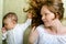 Beautiful woman and her newborn daughter on the couch