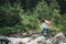 Beautiful woman hiker with backpack near wild mountain river