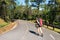 Beautiful woman hiker standing on forest trail and looking away. Female with backpack on hike in nature.