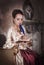 Beautiful woman in historic medieval dress with diary