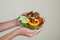 Beautiful woman holding a bowl of fresh veggie salad