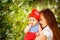 Beautiful woman holding cute curious Toddler Baby