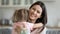 Beautiful woman holding flowers embraces little daughter