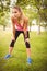 Beautiful woman holding knees in park