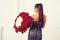 Beautiful woman holding luxury bouquet of 101 roses. Happy Valentine`s day. Luxury fashion girl in evening dress, back view.